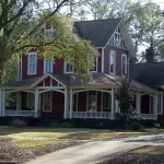 Residential street lined with houses and mature shade trees